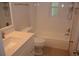 A well-lit bathroom features white fixtures, including a tub, toilet, and vanity at 622 Alton Rd, Winter Springs, FL 32708
