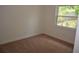 This bedroom features plush carpet, a window, and neutral walls, creating a cozy atmosphere at 622 Alton Rd, Winter Springs, FL 32708