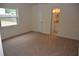 Bright bedroom with carpet flooring, closet, and a door to the bathroom at 622 Alton Rd, Winter Springs, FL 32708