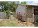 Exterior view of the home with a fenced yard, landscaping, and gate at 622 Alton Rd, Winter Springs, FL 32708