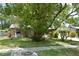 Charming stone home featuring lush landscaping, mature trees, and a well-manicured lawn at 622 Alton Rd, Winter Springs, FL 32708