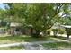 Charming single-story home featuring a stone facade, mature trees, and a well-manicured lawn at 622 Alton Rd, Winter Springs, FL 32708