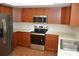 Modern kitchen with stainless steel appliances, updated white countertops, and ample cabinet space at 622 Alton Rd, Winter Springs, FL 32708