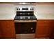 Updated kitchen features stainless steel oven, white countertop, and wooden cabinets at 622 Alton Rd, Winter Springs, FL 32708