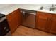 New stainless steel dishwasher next to sink with white counters and wood cabinetry at 622 Alton Rd, Winter Springs, FL 32708