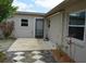 A concrete patio offers outdoor relaxation space with a nearby door and windows at 622 Alton Rd, Winter Springs, FL 32708