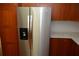 A stainless steel refrigerator is installed with wood cabinets and white countertops at 622 Alton Rd, Winter Springs, FL 32708
