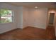 Bright room with wood laminate flooring, a window, a white door, and fresh paint in a renovated home at 622 Alton Rd, Winter Springs, FL 32708