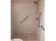 Tiled walk-in shower featuring safety grab bars and modern shower head at 622 Alton Rd, Winter Springs, FL 32708