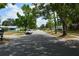 Neighborhood street view with mature trees and well-maintained houses on both sides of the road at 622 Alton Rd, Winter Springs, FL 32708
