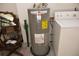 Utility room featuring a water heater and a washing machine at 622 Alton Rd, Winter Springs, FL 32708