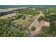 Aerial view showcasing a property nestled among trees, highlighting its spacious grounds and natural surroundings at 6803 Round Lake Rd, Mount Dora, FL 32757