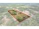 Expansive aerial view of property with red outline, showcasing the home, pool, and surrounding acreage at 6803 Round Lake Rd, Mount Dora, FL 32757