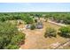Aerial shot featuring a well-maintained home with fenced yard, detached garage, and scenic surroundings at 6803 Round Lake Rd, Mount Dora, FL 32757