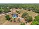 Picturesque aerial view of property with pool, fenced yard, and serene landscape at 6803 Round Lake Rd, Mount Dora, FL 32757