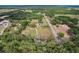 Overhead view of the property nestled in a lush, wooded area, accessible by a private driveway at 6803 Round Lake Rd, Mount Dora, FL 32757