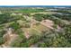 Aerial view of property surrounded by lush greenery and neighboring residences, offering a serene countryside setting at 6803 Round Lake Rd, Mount Dora, FL 32757