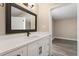 Modern bathroom with a white vanity, matte black faucet and mirror at 6803 Round Lake Rd, Mount Dora, FL 32757