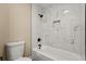 Modern bathroom with white marble tile surround, black fixtures, and a shower-tub combination at 6803 Round Lake Rd, Mount Dora, FL 32757