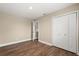 Clean bedroom featuring wood-look floors, neutral wall color, and closet at 6803 Round Lake Rd, Mount Dora, FL 32757