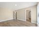Spacious bedroom featuring three doorways and light wood flooring at 6803 Round Lake Rd, Mount Dora, FL 32757