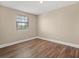 Well-lit bedroom featuring wood-look floors and neutral wall color at 6803 Round Lake Rd, Mount Dora, FL 32757