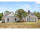Charming home exterior with dormer windows, brick chimney, and landscaped front yard at 6803 Round Lake Rd, Mount Dora, FL 32757