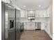 Modern kitchen with white cabinets and stainless steel refrigerator at 6803 Round Lake Rd, Mount Dora, FL 32757