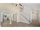 Open-concept living space with view into modern kitchen and staircase at 6803 Round Lake Rd, Mount Dora, FL 32757