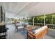 Covered patio with comfortable seating and views of the surrounding greenery at 6803 Round Lake Rd, Mount Dora, FL 32757