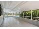 Enclosed tile patio with a view of a pool and green trees at 6803 Round Lake Rd, Mount Dora, FL 32757