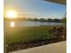 Backyard view showing community pond at sunset at 734 Via Como St, Poinciana, FL 34759