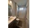Bathroom with tub-shower combo, modern vanity and neutral color palette at 734 Via Como St, Poinciana, FL 34759