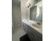 Bathroom featuring double sinks, grey cabinetry, and a large mirror at 734 Via Como St, Poinciana, FL 34759