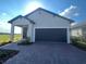 Charming single-story home featuring a two-car garage and inviting covered entry at 734 Via Como St, Poinciana, FL 34759