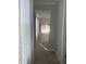 Hallway view leading into an open-concept kitchen and dining area with modern decor at 734 Via Como St, Poinciana, FL 34759