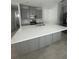 Kitchen island featuring grey cabinets, a white countertop, and a stainless steel faucet at 734 Via Como St, Poinciana, FL 34759