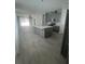 Open-concept kitchen featuring a large island, gray cabinetry, and modern appliances at 734 Via Como St, Poinciana, FL 34759
