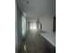 Bright, open living room with wood-look tile flooring and abundant natural light at 734 Via Como St, Poinciana, FL 34759