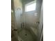 Modern bathroom shower with glass door, showerhead and tiled surround at 734 Via Como St, Poinciana, FL 34759