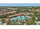 Aerial view of community pool with lounge seating, lush tropical landscaping, and community clubhouse at 7554 Oak Spring Ln, Davenport, FL 33837