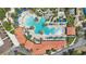 Aerial view of community pool with lounge seating, lush tropical landscaping, and community clubhouse at 7554 Oak Spring Ln, Davenport, FL 33837