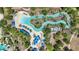 Aerial view of a lazy river with lounge seating and lush tropical landscaping at 7554 Oak Spring Ln, Davenport, FL 33837