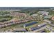 An aerial view showcases the community with its ponds, landscaping, and well-maintained homes at 7554 Oak Spring Ln, Davenport, FL 33837