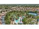 Aerial shot featuring a resort-style pool, lazy river, tennis courts and lush landscaping at 7554 Oak Spring Ln, Davenport, FL 33837