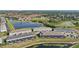 Aerial view showcasing a community with ponds, well-kept lawns, and modern townhouses at 7554 Oak Spring Ln, Davenport, FL 33837