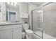Bathroom with a granite countertop vanity, decorative art, and a glass door shower at 7554 Oak Spring Ln, Davenport, FL 33837