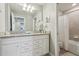 Bathroom featuring a granite countertop vanity, decorative art, and a tub with a shower at 7554 Oak Spring Ln, Davenport, FL 33837