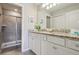Bright bathroom featuring a granite countertop, double sink vanity, and tiled walk-in shower at 7554 Oak Spring Ln, Davenport, FL 33837