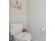 Clean bathroom with a standard toilet, updated fixtures, and modern wall art at 7554 Oak Spring Ln, Davenport, FL 33837
